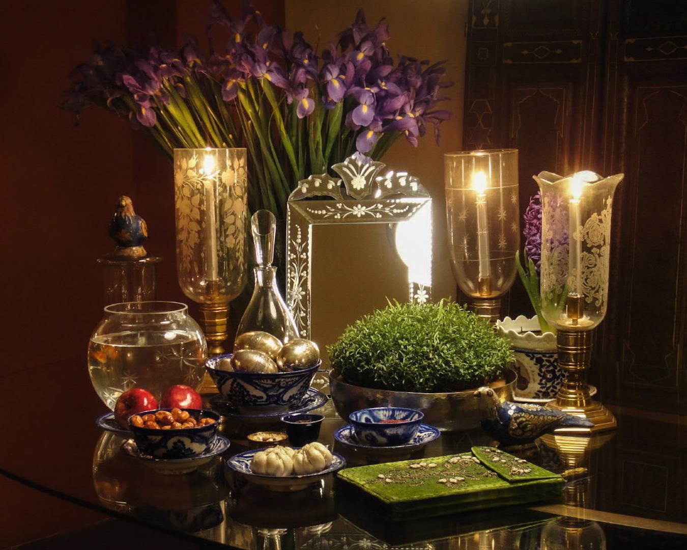 Photo of a Haft Sin, a traditional tabletop decoration that is formed from seven symbolic items.